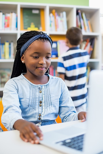 young girl using a tablet at her desk