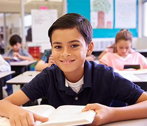 Boy smiling and holding book