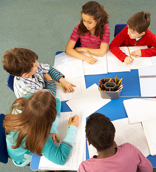 students at a table writing