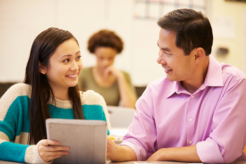 teacher and student at table