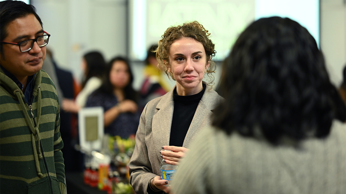 Three people gathered in conversation