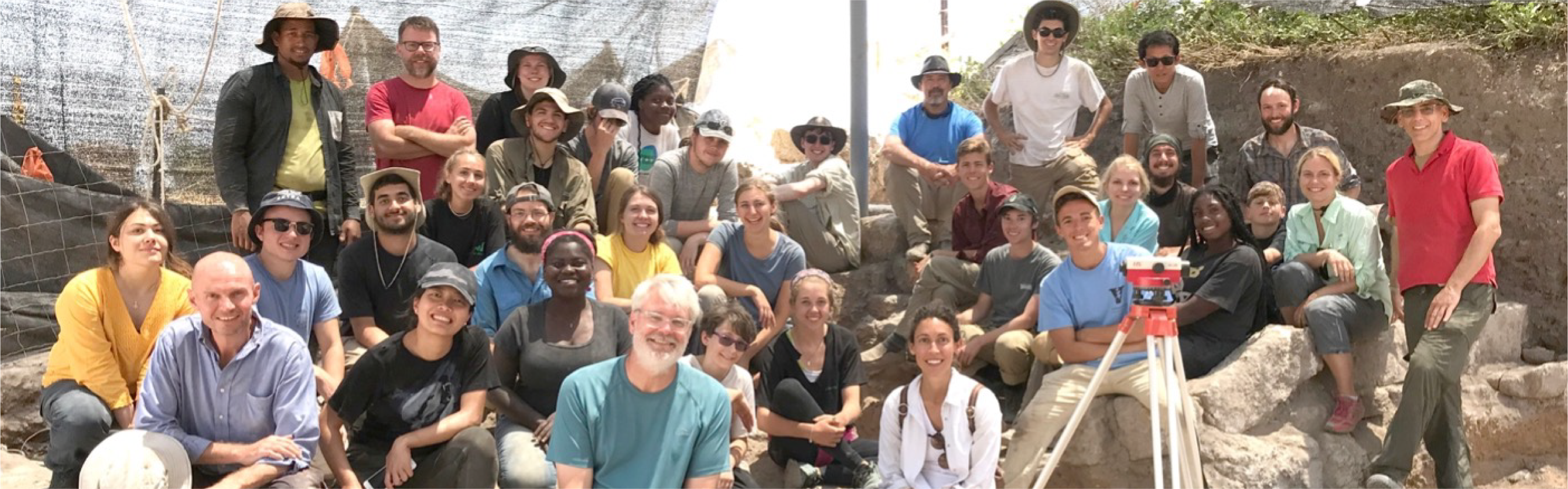 Students and faculty psoing for a photo on an archaeological site