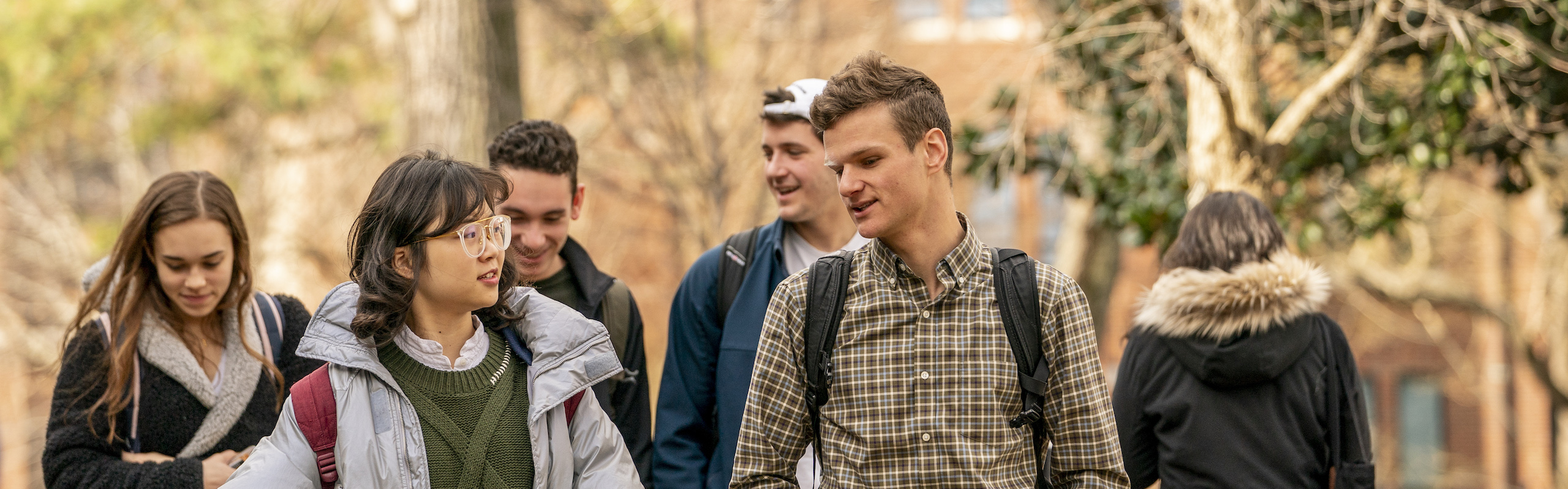 Two students in conversation walking through campus