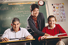 Teacher instructing two students