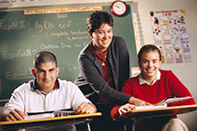 Teacher instructing two students