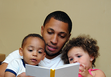 father reading to children