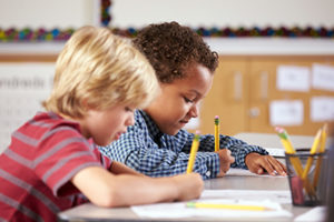 Two boys working on assignment at desk