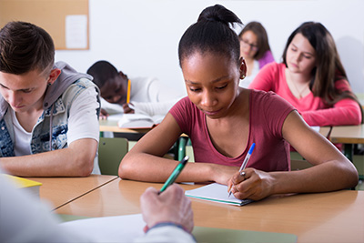 girl writing at desk