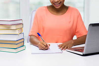 teacher at her desk writing