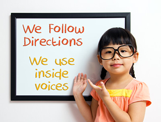 girl in front of directions board