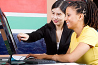 two students working on a computer