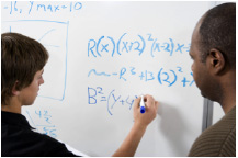 student writing on whiteboard