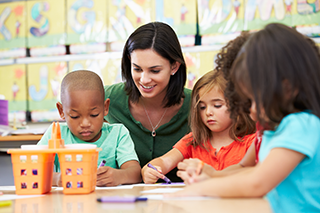 teacher and students at table activity