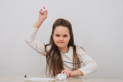 Kristen throwing wadded paper