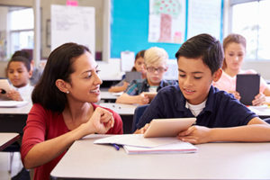 Woman helping boy with assignment