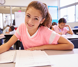 Girl smiling while working on assignment