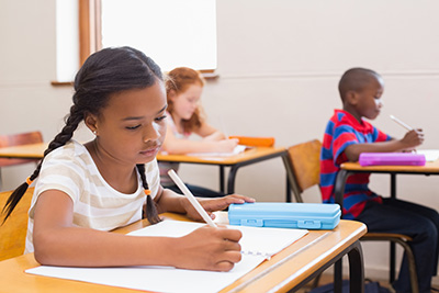 girl at desk writing