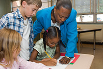 Teacher helping a student 