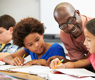 child and teacher with writing assignment
