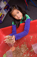 girl playing in sand