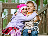 little girl hugging little boy