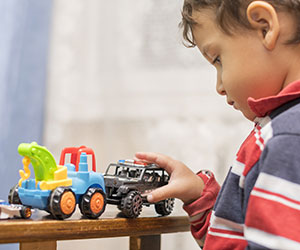 boy playing with toy cars