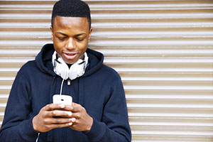 teen boy with electronic device