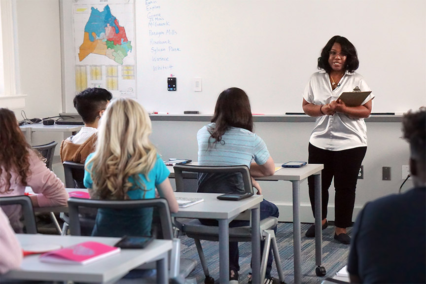teacher standing in front of her class