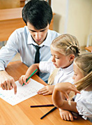 teacher helping two students