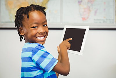 young boy pointing at iPad