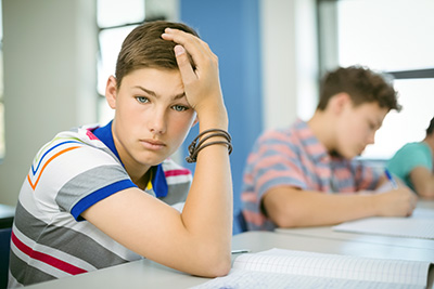 student at table, looking at you