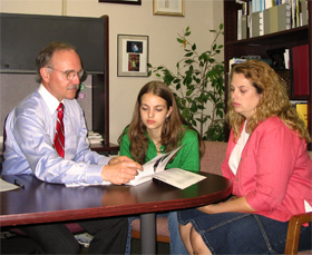 Teacher with student and mother