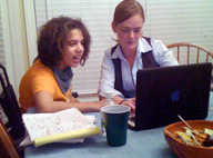 Teacher and student working on a laptop