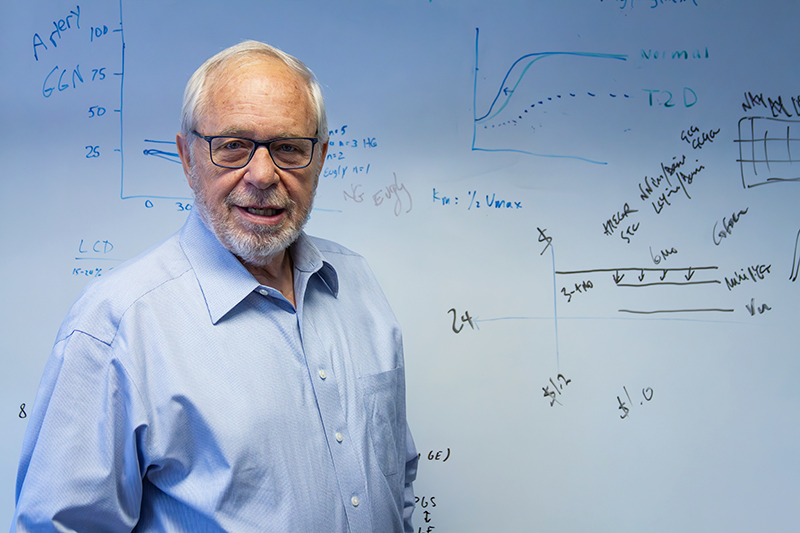 Alan Cherrington standing in front of a white bo.ard