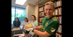 Buchanan Fellow holds artifact from Special Collections