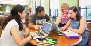 Librarian works with 3 students