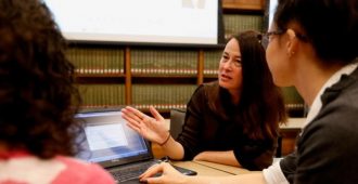 Librarian Pam Morgan teaches at a desk