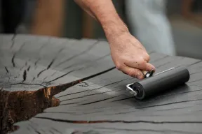 Art students watch as artist Marko Barakoski makes tree prints at E. Bronson Ingram Studio Arts Center using wood from the Bicentennial Oak that fell on campus in 2022.