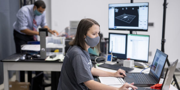 Researchers in masks in campus lab