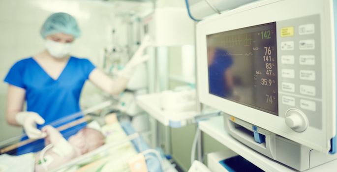 Surgery and intensive care unit. Female doctor or nurse in surgical child neonatal hospital with artifical lung ventilation device (Surgery and intensive care unit. Female doctor or nurse in surgical child neonatal hospital with ventilator