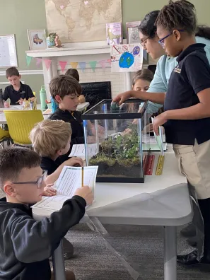 An SSMV student works with Roberts Academy learners.