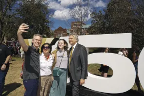 Chancellor Daniel Diermeier greeted members of the university community at the March 25 celebration on Alumni Lawn and posed for a few group selfies in front of the V150 backdrop.