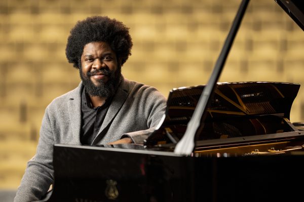 Dashon Burton sitting at the piano in Blair's Steve and Judy Turner Recital Hall