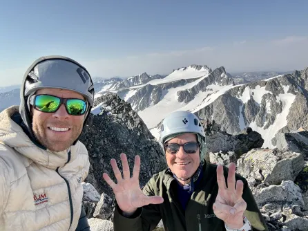 Tim McNamara and a friend celebrate reaching their eighth peak in the mountains of Wyoming. (Submitted photo)