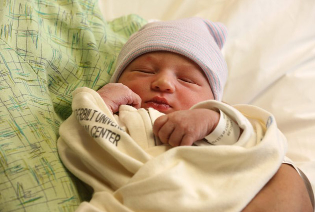 Elijah Youssef sleeps peacefully in his mother’s arms, unaware of the panic and turmoil surrounding his arrival. (Anne Rayner/Vanderbilt)