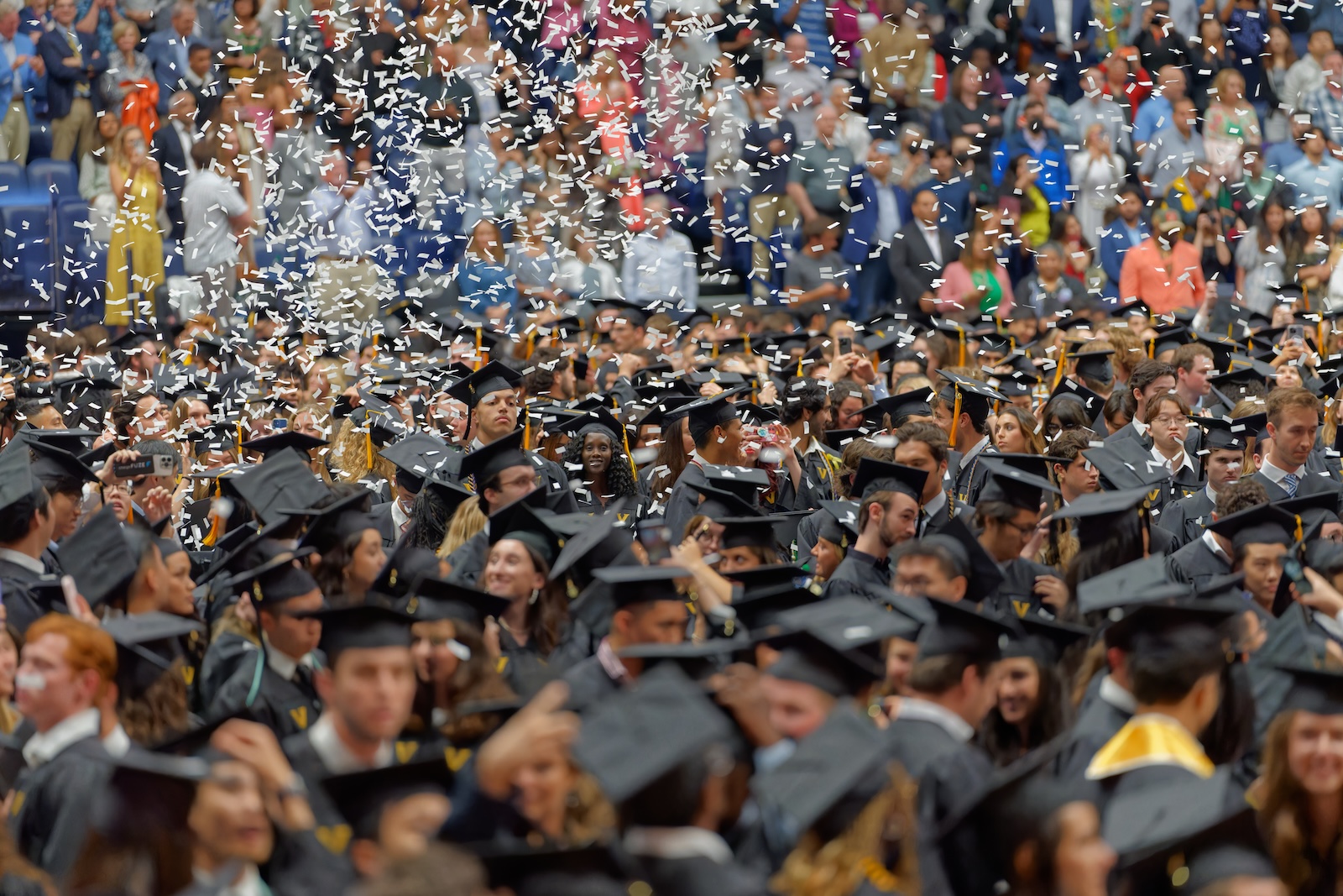 Confetti falls over graduates at Commencement 2024. 