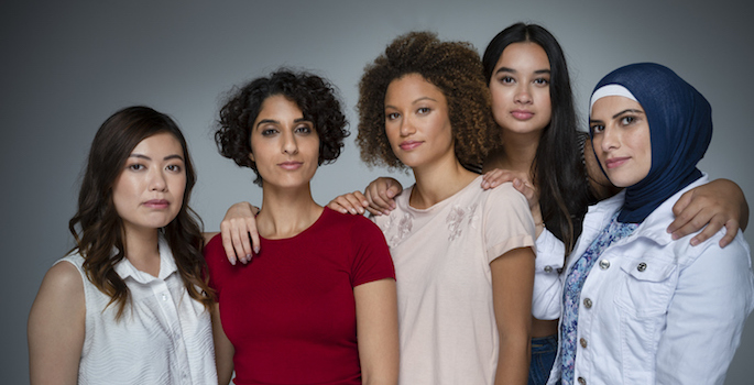 Portrait of a Group of women in the studio. Multi-ethnic group including Caucasian, Hispanic, middle eastern, Asian and African American. One middle eastern woman is wearing a hijab (Portrait of a Group of women in the studio. Multi-ethnic group inclu