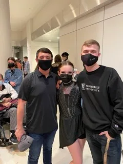 Mason TeVrucht (left, Class of 2023) and Blake Christiansen with Nicole Wright (right, Class of 2022) immediately after the Fall 2021 Vitality Dance Company Showcase.