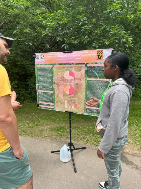 Day of Discovery student presenting poster at the Nashville Zoo