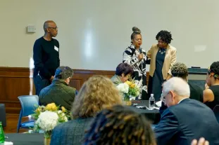Bishop Joseph W. Walker III, left, and Pastor Catina Parrish-Clark, center, both of Mt. Zion Baptist Church, and Vanderbilt Divinity School alumni pray with Dean Yolanda Pierce, right, at the Divinity School breakfast event on Sept. 19, 2023. (Harrison McClary/Vanderbilt University)